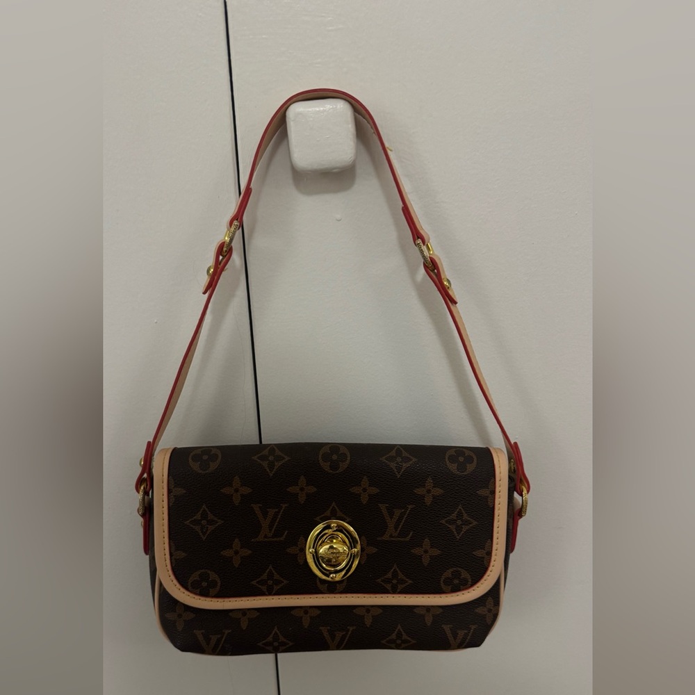 Brown monogrammed shoulder bag with red trim